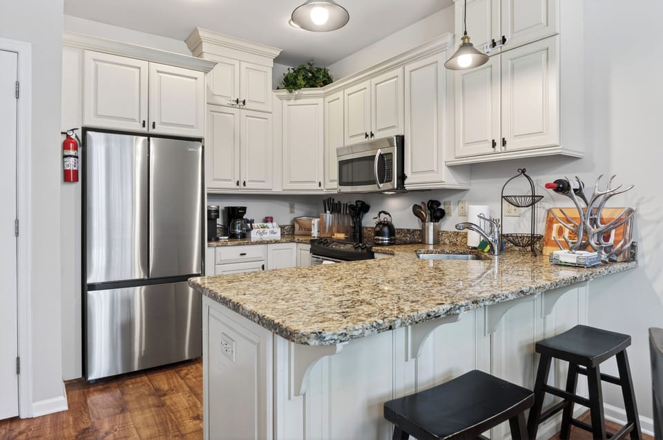 Modern chef's kitchen with barstool seating.