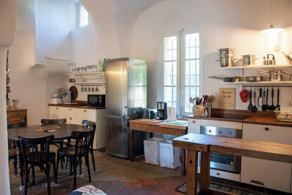 Fully equipped kitchen with wooden countertops and open shelving.