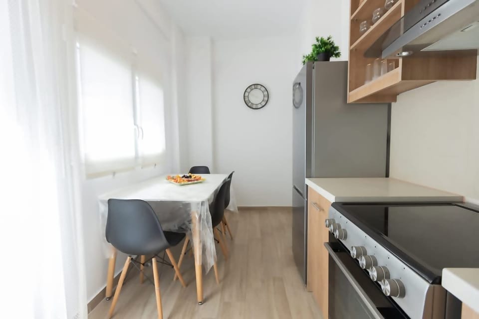 Fully equipped kitchen with refrigerator, oven, stove, and all cooking essentials.