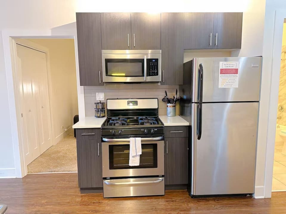 A cozy kitchen with dark wood cabinets and a traditional gas stove, offering a warm, functional cooking space.