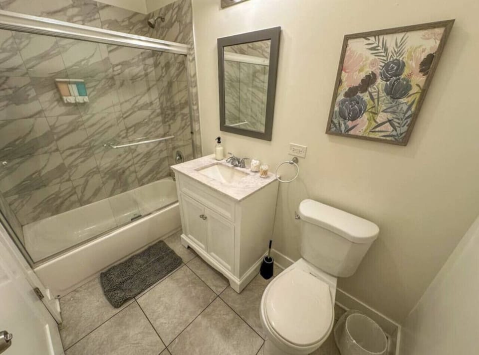 Clean bathroom with full tub and modern finishes.