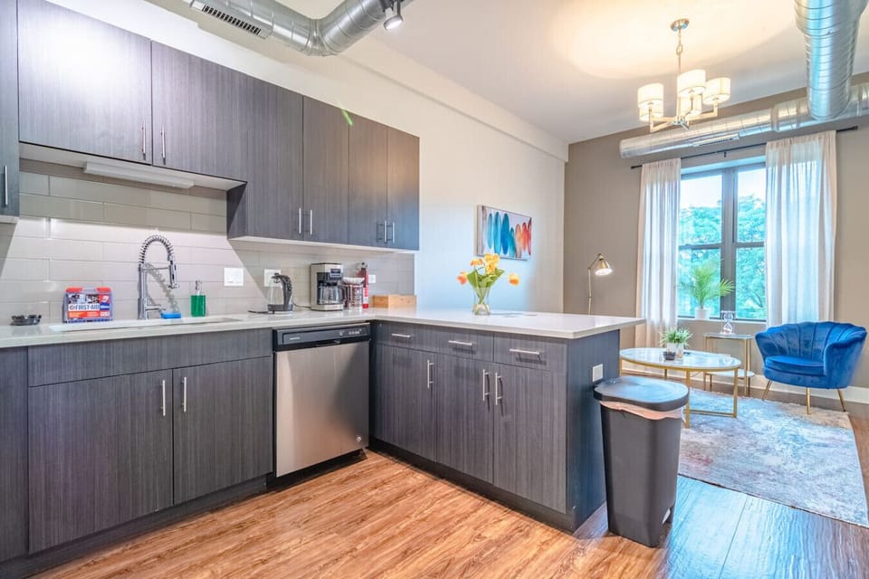 Stylish open-concept kitchen with stainless steel appliances, generous counter space, and bar seating — perfect for easy meals and entertaining.
