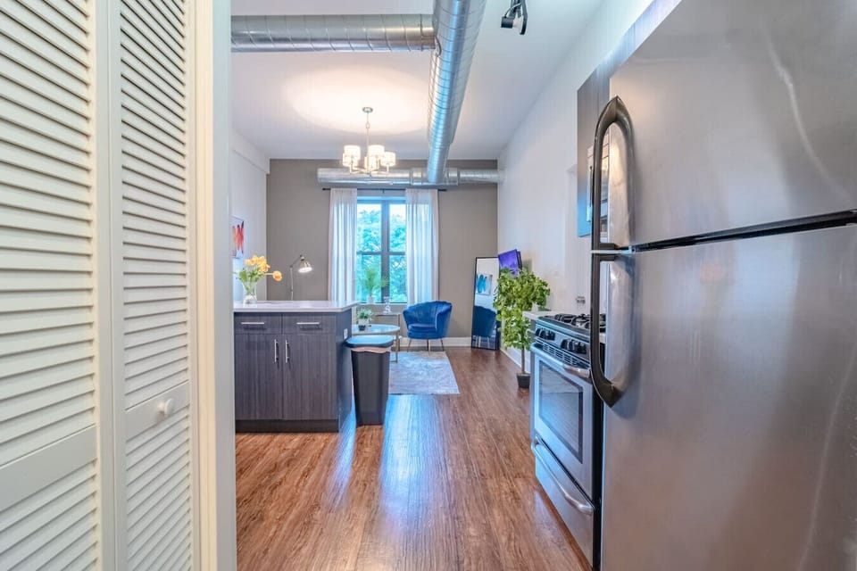 Stylish open-concept kitchen with stainless steel appliances, generous counter space, and bar seating — perfect for easy meals and entertaining.