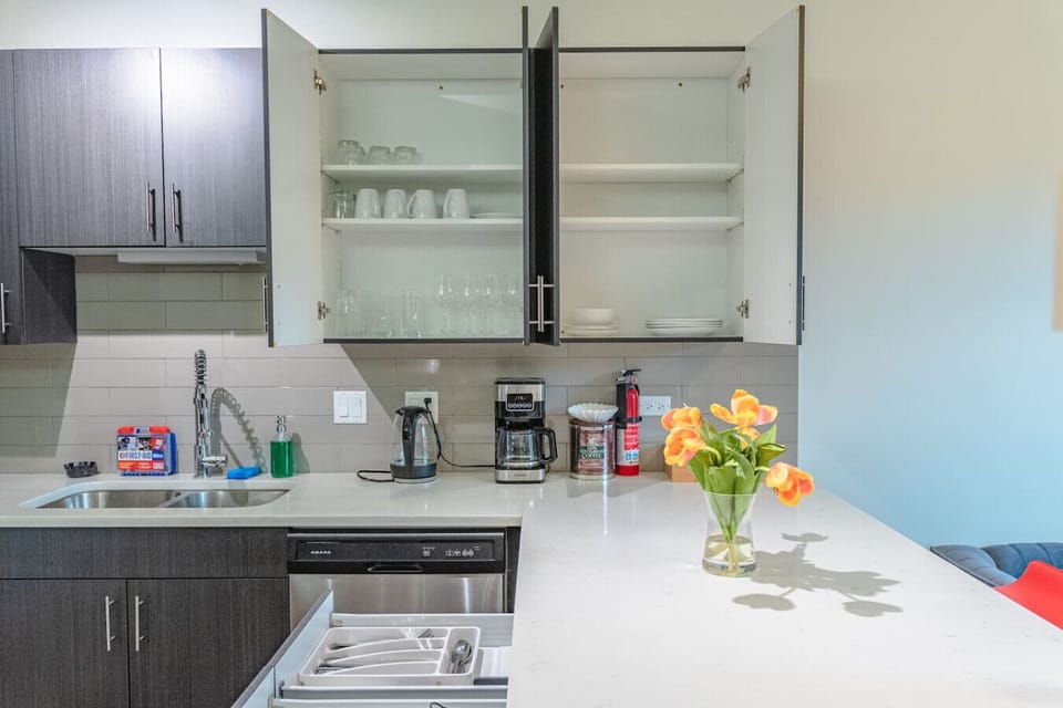 Stylish open-concept kitchen with stainless steel appliances, generous counter space, and bar seating — perfect for easy meals and entertaining.