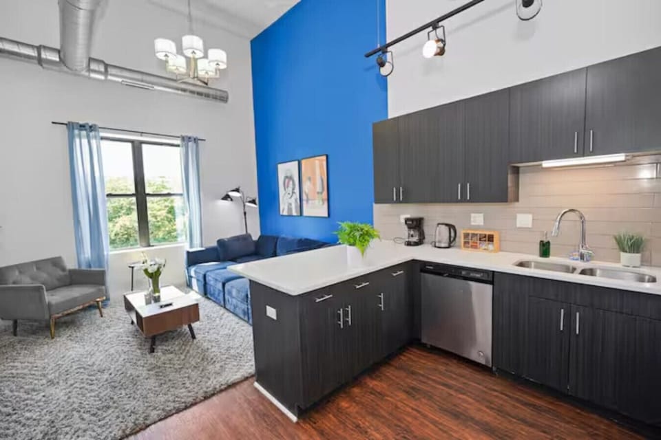 Bright open-concept living space with modern kitchen, high ceilings, and beautiful natural light.