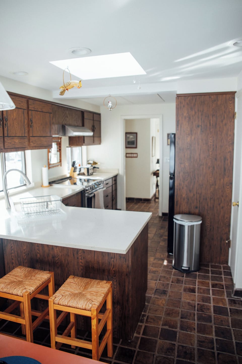 Large sunny kitchen with skylight, quartz counters, bar seating