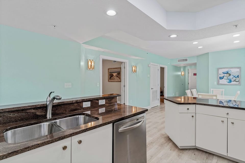Your modern kitchen features granite countertops, stainless steel appliances, and calming mint walls that create a fresh, inviting cooking space.