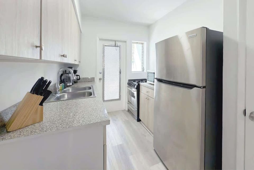 Fully equipped kitchen with stove, fridge, microwave, and all essential cookware (no dishwasher).