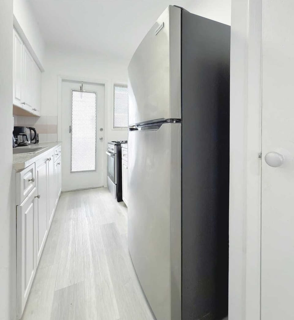 Fully equipped kitchen with fridge, stove, microwave, and cookware (no dishwasher).