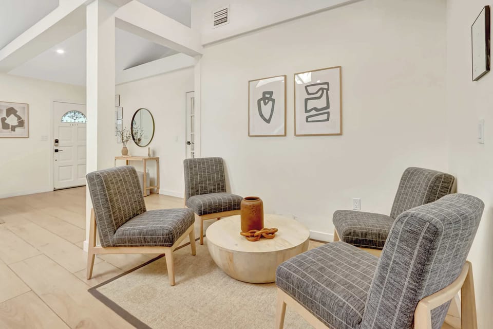 Relax in the spacious living room with cozy seating and a smart TV for your favorite shows.