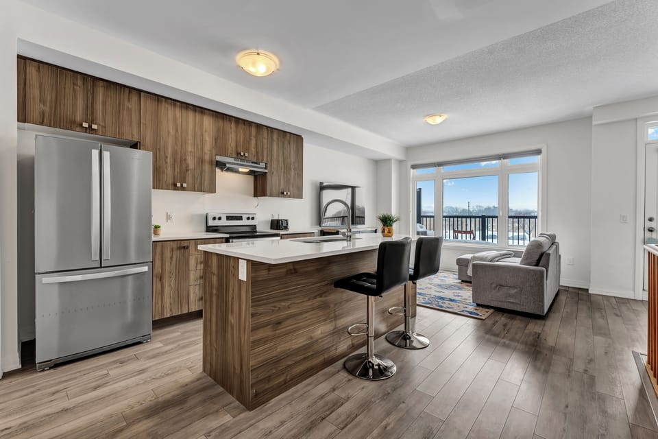 Stainless steel refrigerator and gas range in a chef-ready kitchen
