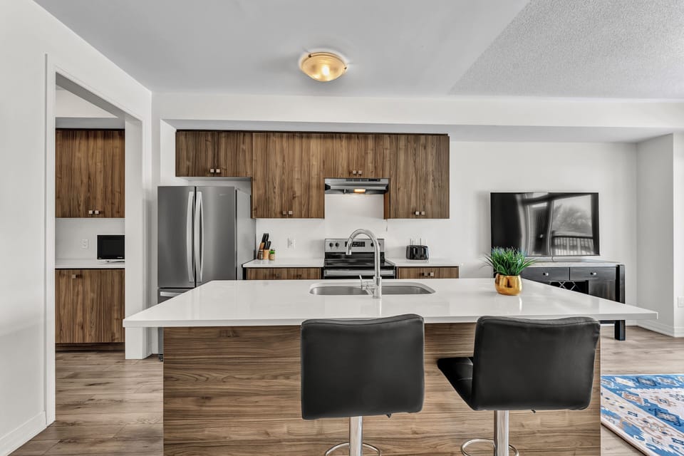 Modern kitchen island with breakfast bar seating and pendant lighting