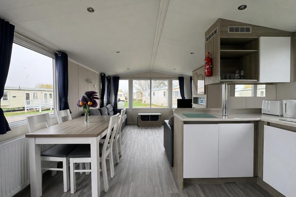 Enjoy the convenience of a cosy kitchen area in a caravan, perfect for family meals on your UK family holiday.