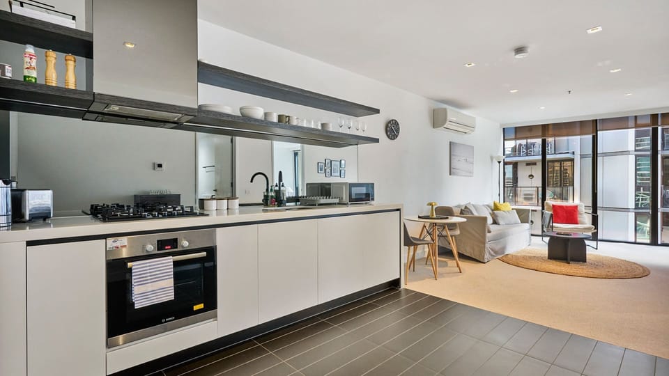 Sleek modern kitchen with stainless steel appliances and ample bench space.