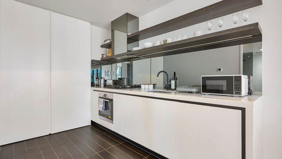 Fully equipped kitchen with oven, microwave, and generous storage.