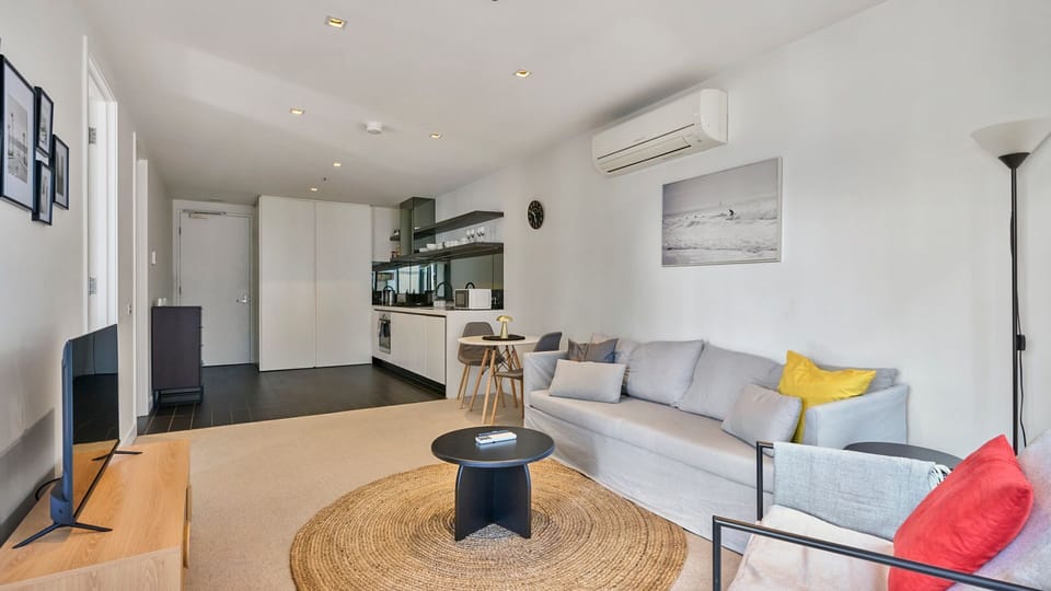 Spacious lounge with smart TV and cozy seating.