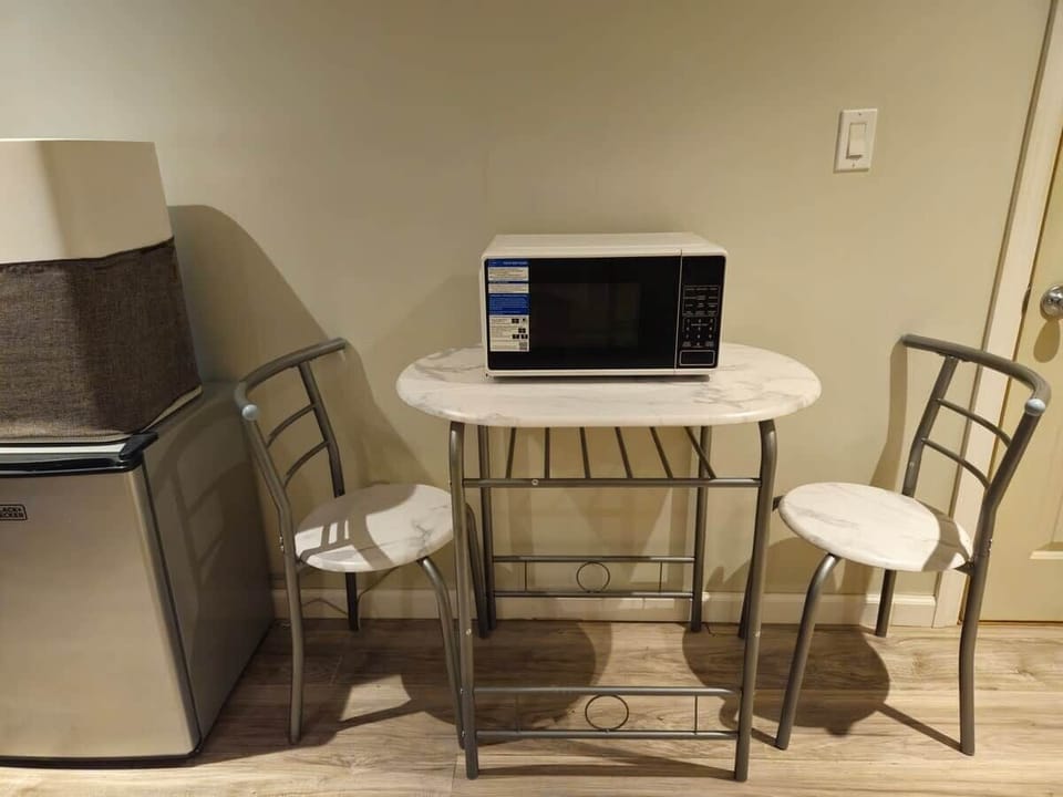 Dinnete with microwave, mini fridge, and air filter.