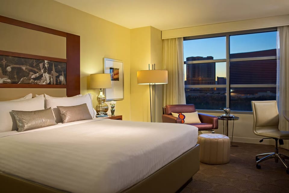 Settle into a spacious king bed with sunset city views.