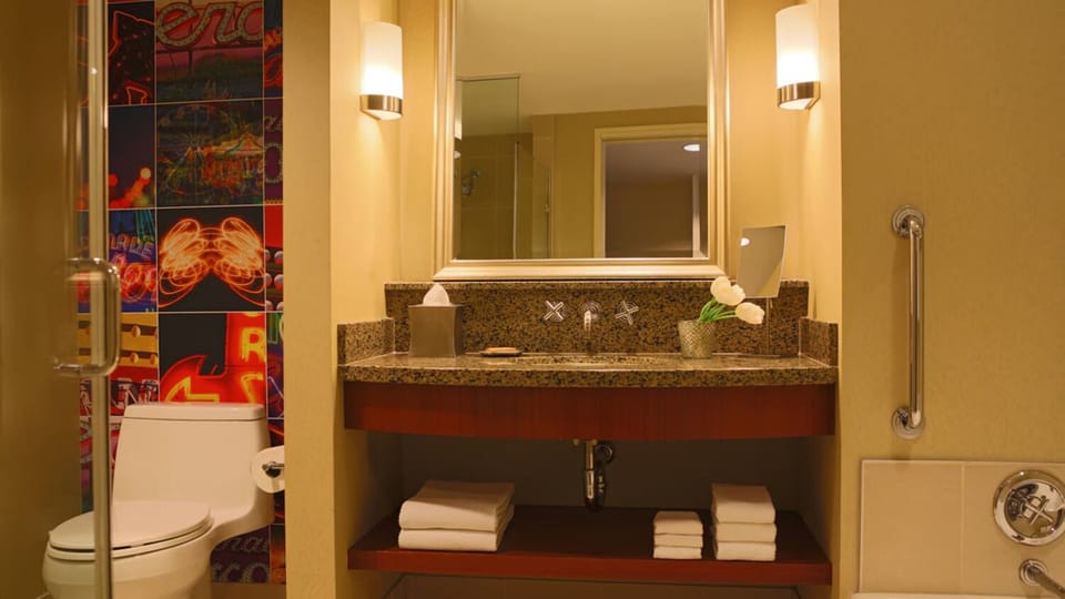 Get ready at a granite vanity with warm, flattering lighting.