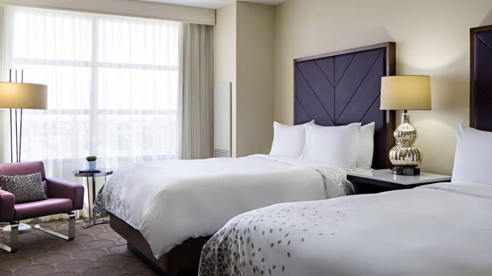 Stretch out in double beds beside sunny windows and cozy seating.