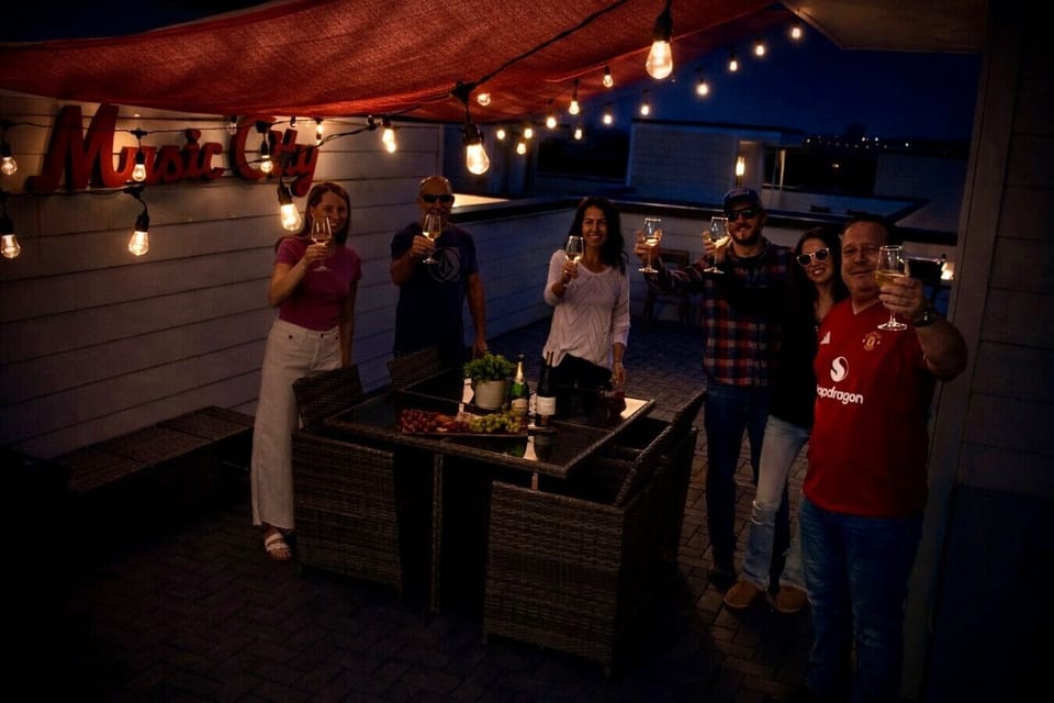Gather around the outdoor table for an evening dinner under the string lights. 🍽️✨
