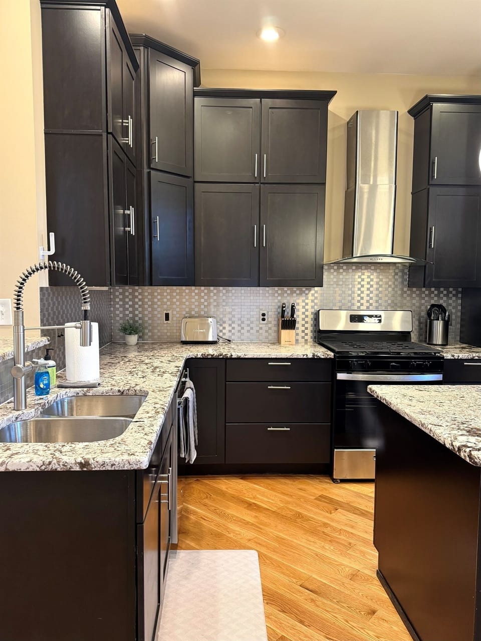 Granite counters in kitchen with newly finished cabinets
