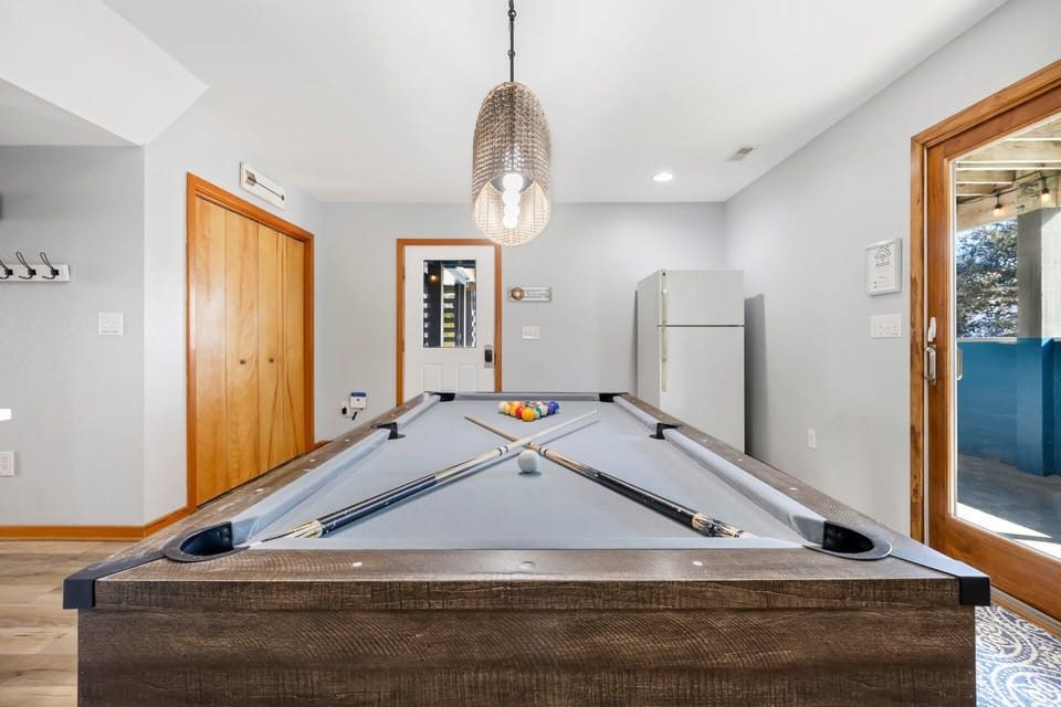 The ground-level game room features a pool table for hours of indoor entertainment.