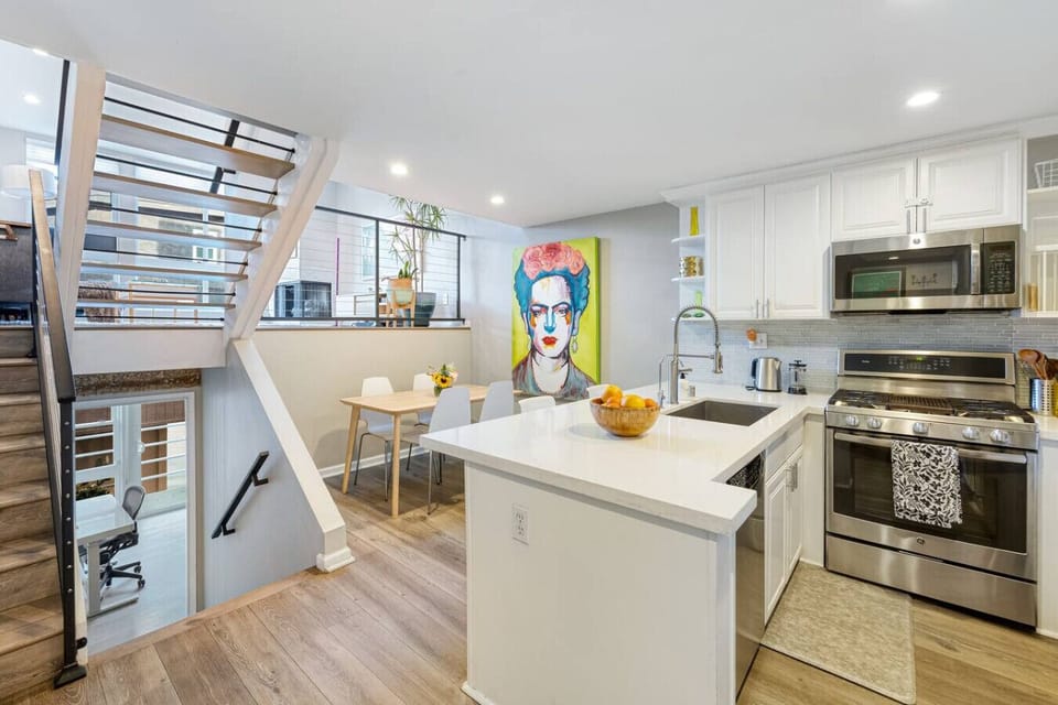 Cook, dine, and relax in this airy open-plan kitchen featuring a large island, modern finishes, and plenty of natural light.