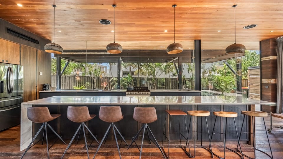 Modern open-plan kitchen with a generous breakfast bar for relaxed dining.