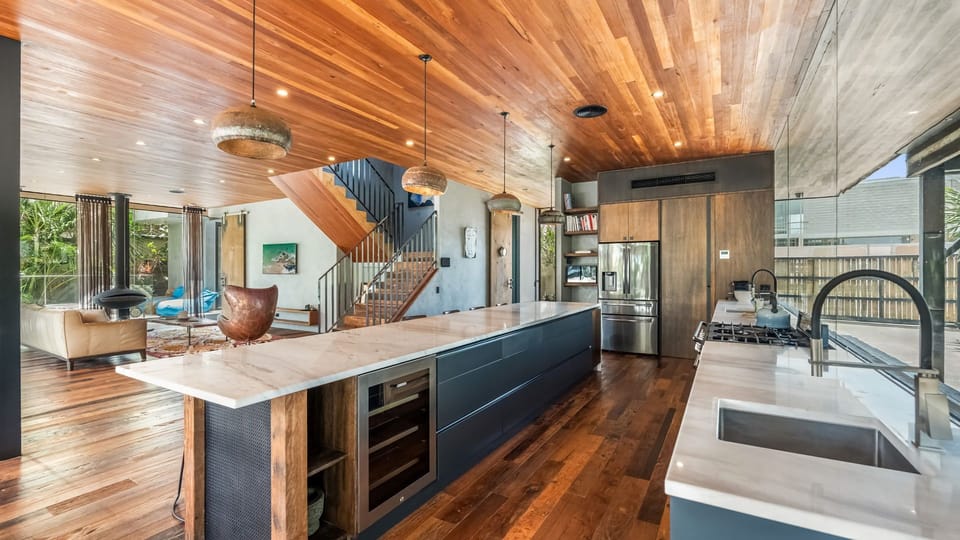 Spacious kitchen with timber ceilings and ample bench space for cooking.