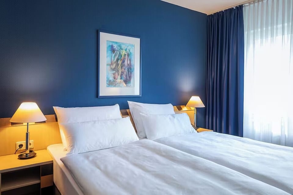 Drift off in crisp linens framed by cozy bedside lighting.
