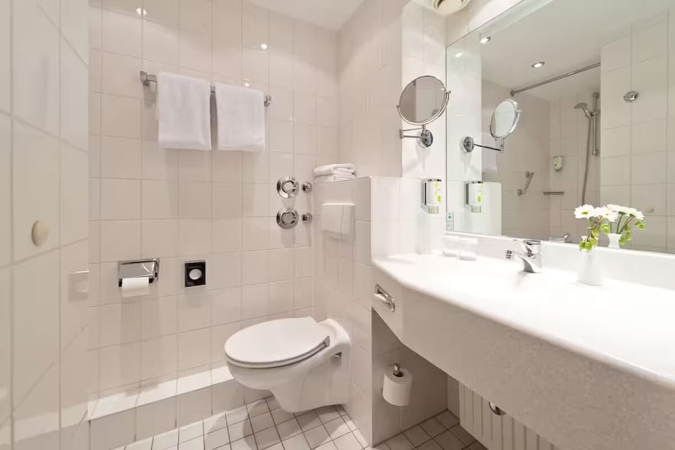 Unwind in a clean, airy bathroom with generous counter space.