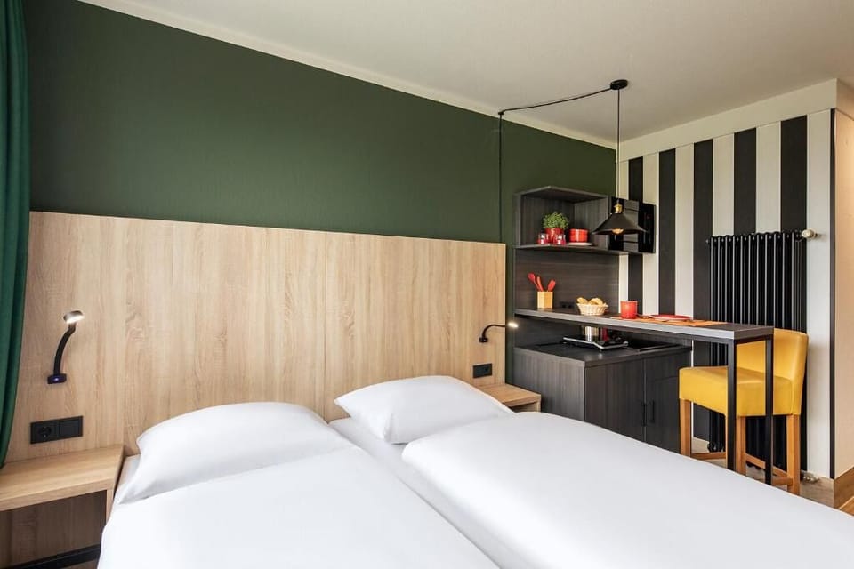 Unwind in crisp twin beds beside your private kitchenette.