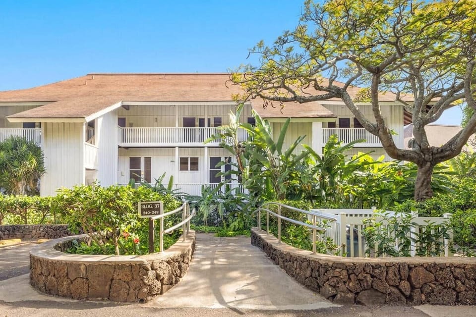 Charming island condo surrounded by lush tropical gardens and palm-lined walkways.