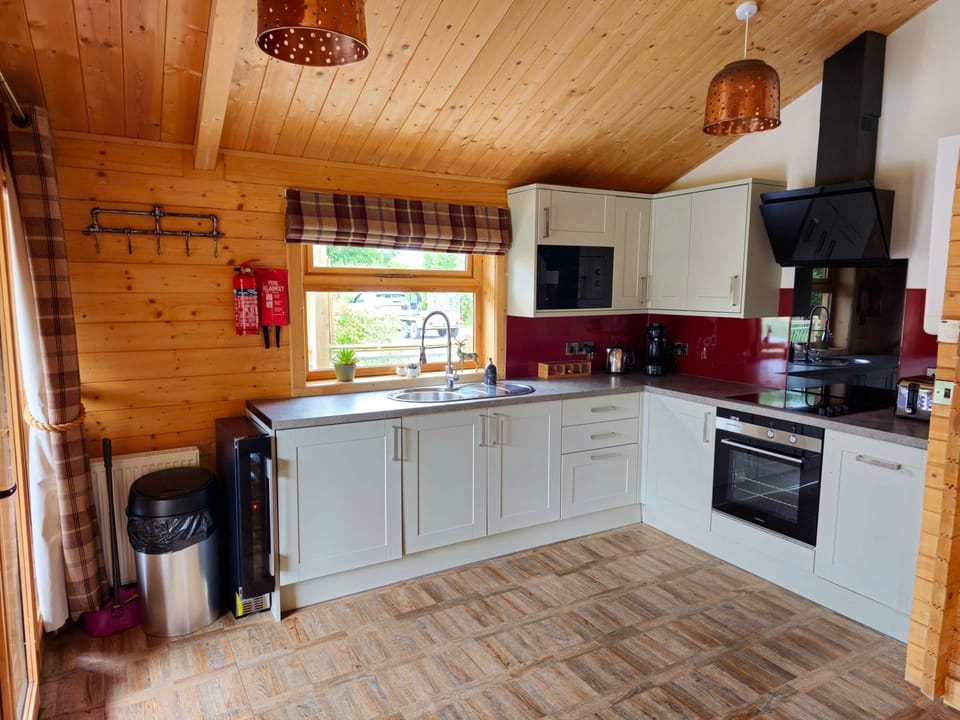 Open plan kitchen with wine cooler, fridge, oven, hob, built in microwave, kettle, dolce gusto 
