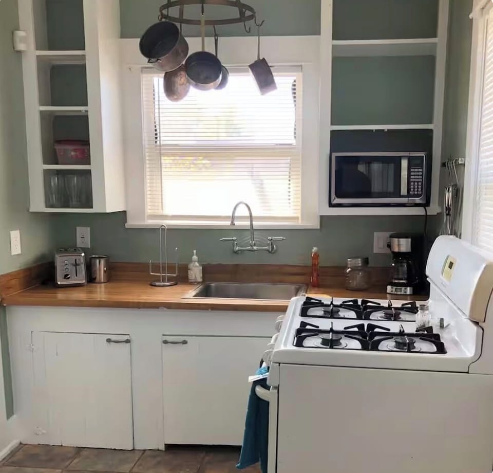 Full kitchen with refrigerator, stove, microwave, coffee maker, utensils, etc...