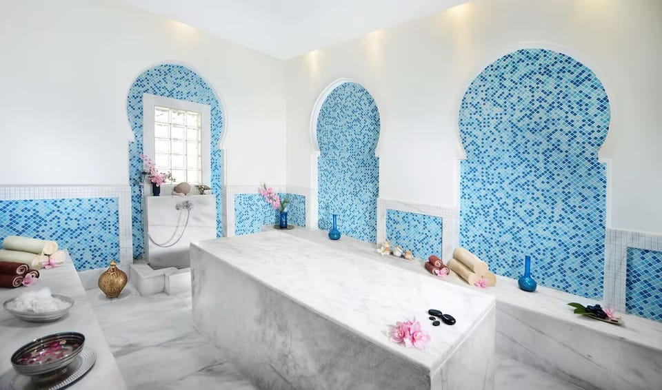 Indulge in serene hammam rituals on cool marble loungers.