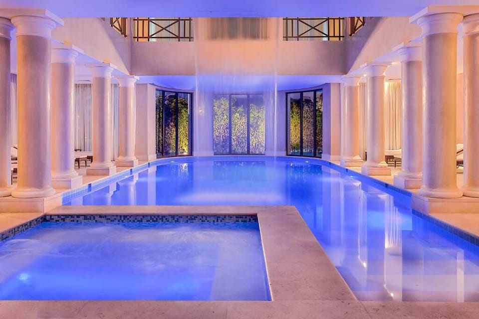 Unwind in serene indoor waters under glowing evening light.