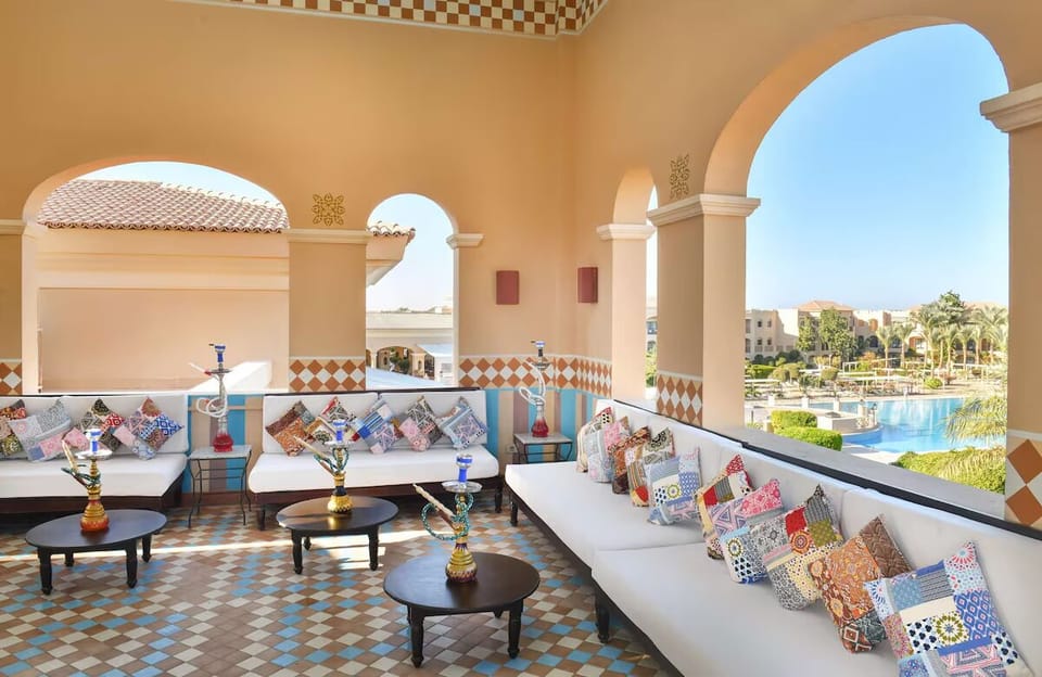 Unwind on the breezy terrace with panoramic pool views.