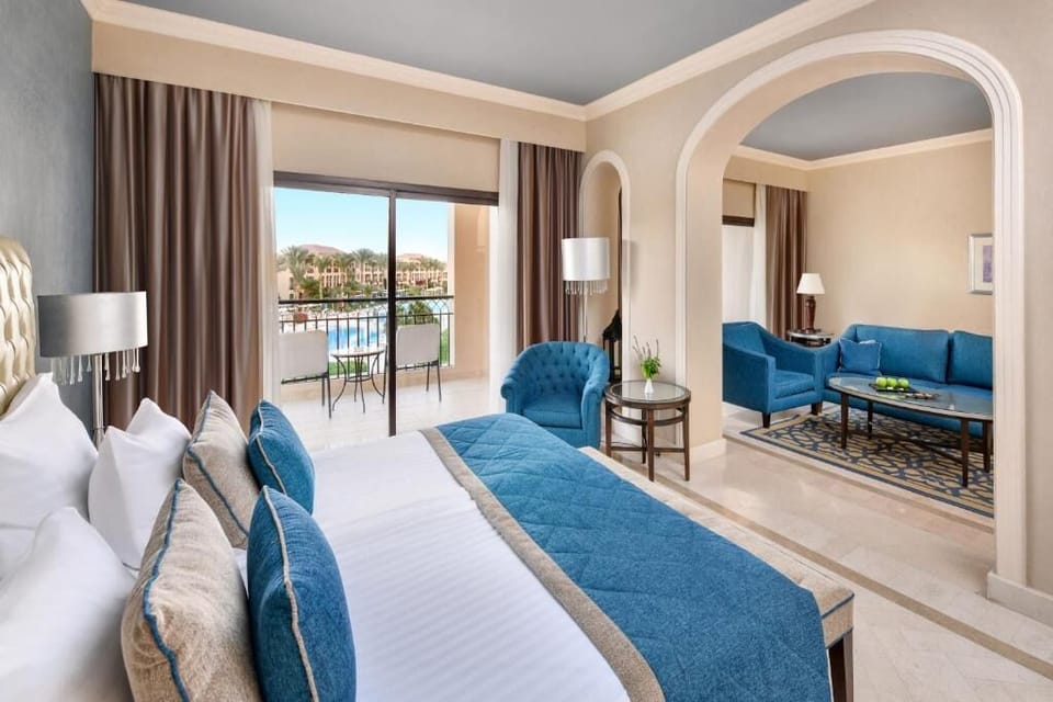 Unwind in a spacious suite with balcony and cozy lounge.