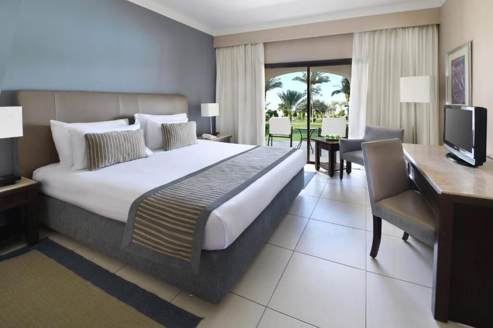 Sink into a plush king bed beside the sunny balcony.