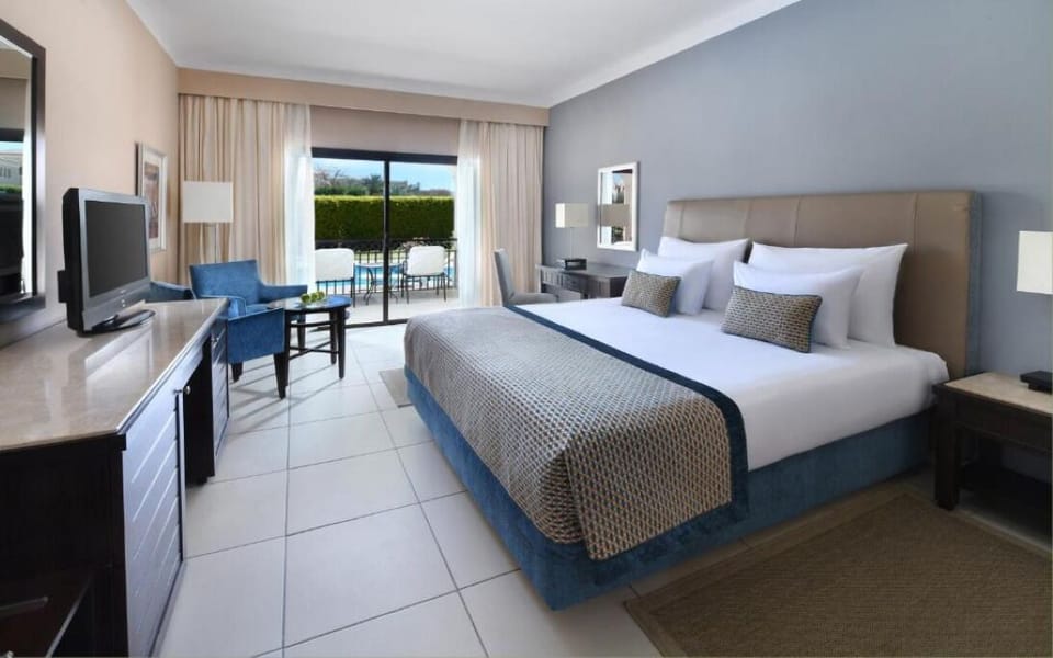 Wake refreshed in crisp linens with terrace light pouring in.