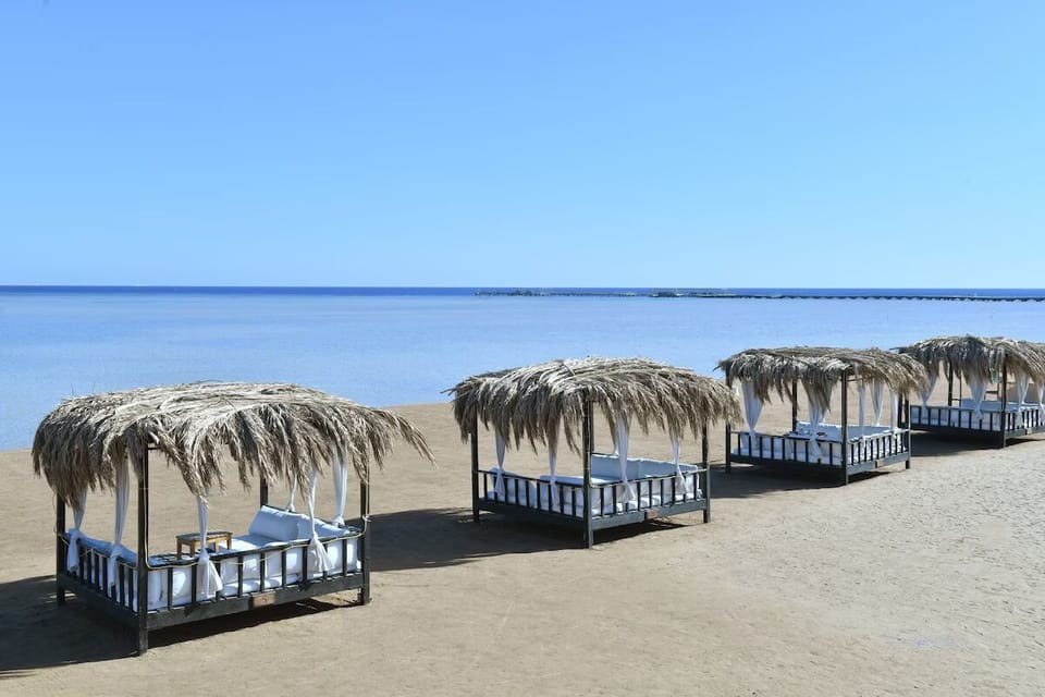 Stroll the private shoreline lined with palms and loungers.