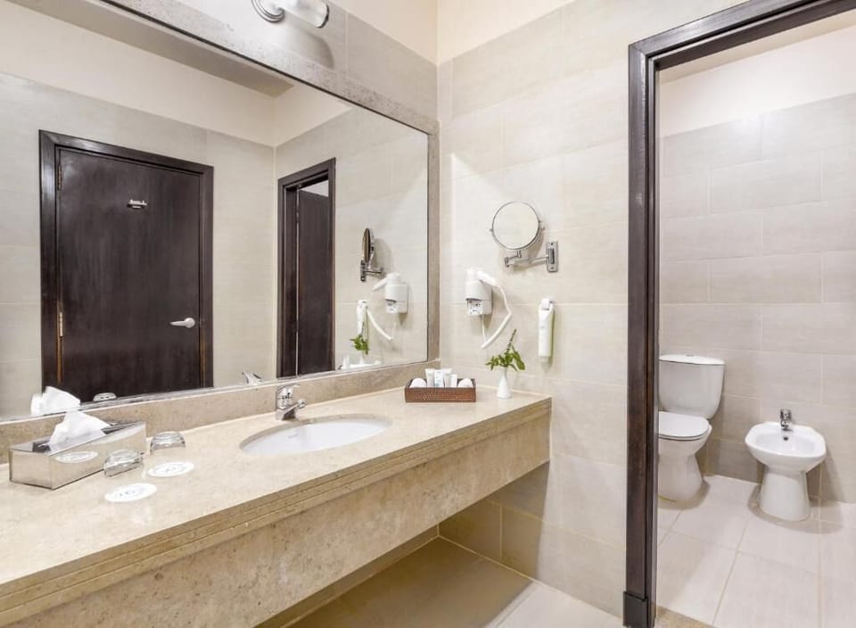 Refresh at the spacious vanity with bright mirror lighting.