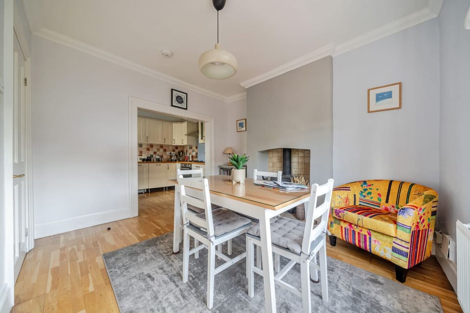 Dining area with a view through the open doorway into the fitted kitchen beyond.