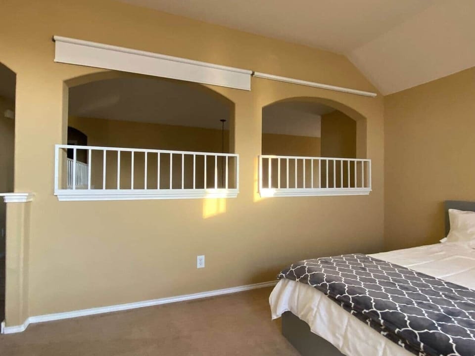 Pull down shades in archways help make the flex space a perfect place for bedtime 