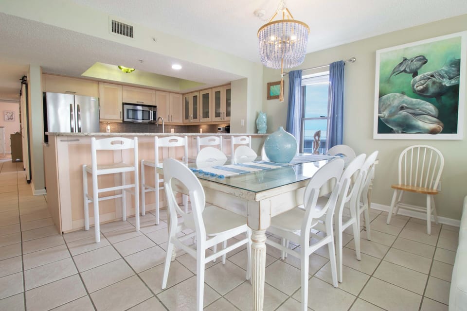 Gather around your bright dining space with coastal charm, where meals become memorable moments under elegant lighting.