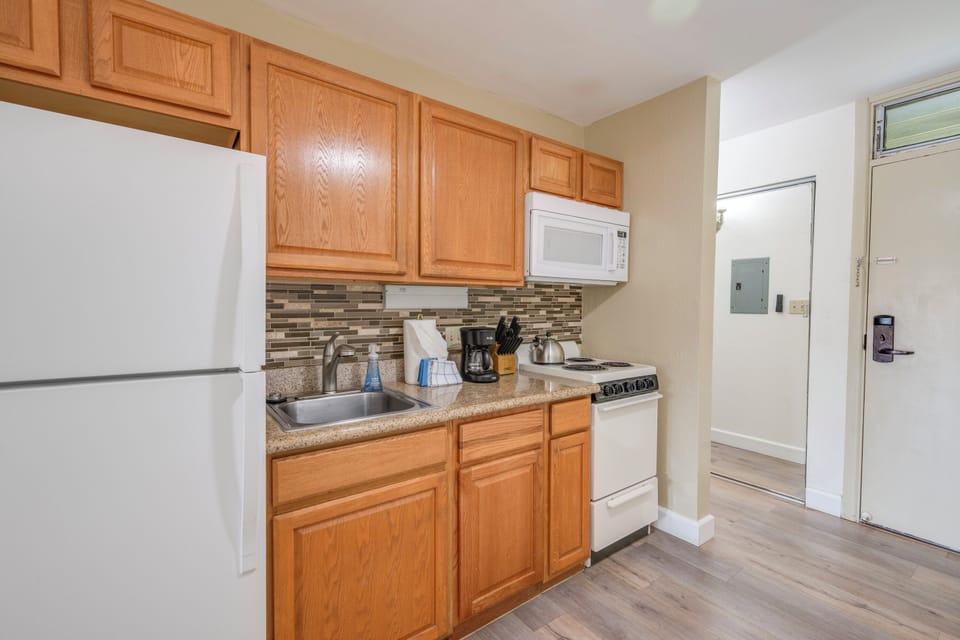 Features warm wood cabinets, granite countertops, and modern appliances—perfect for preparing meals during your stay.