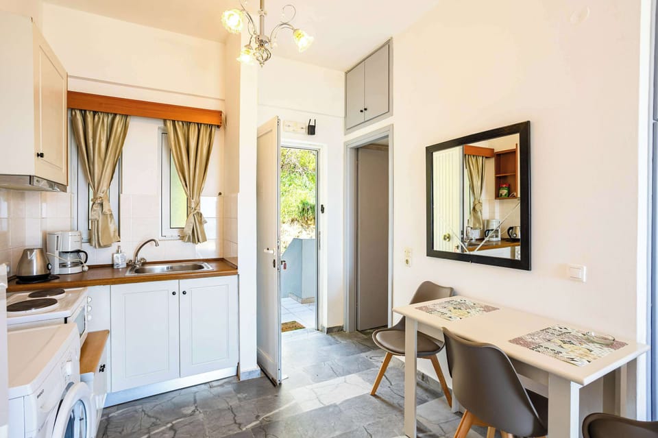 Open Kitchen and Dining Area with Balcony Access