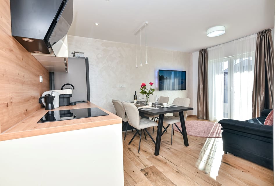 Open-concept living space with a modern kitchen and a cozy TV area.